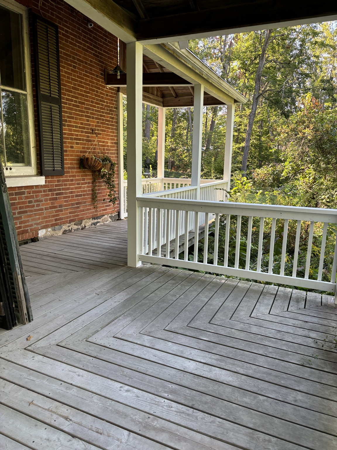 Restored porch posts and rebuilt white railings